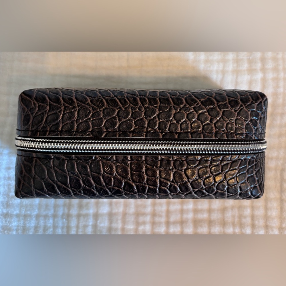 Textured brown makeup bag.
